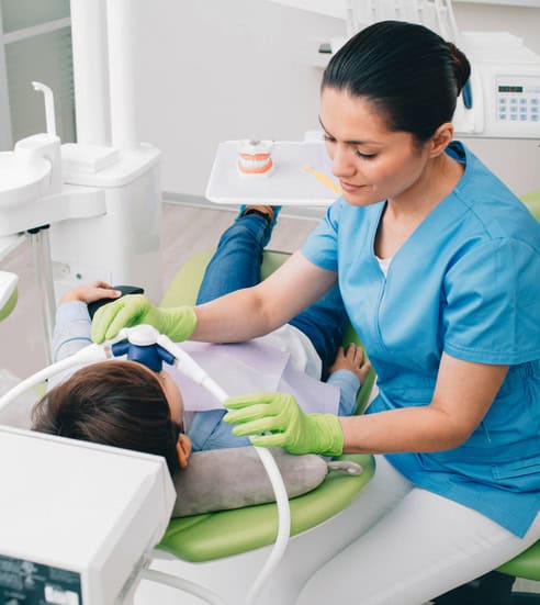 Pediatric dentist doing Inhalation Sedation to a child while teeth treatment at dental clinic. Sedation Dentistry