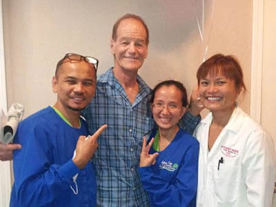 Dr. Hoang Truong and her Gateway Oaks Dental team with a patient
