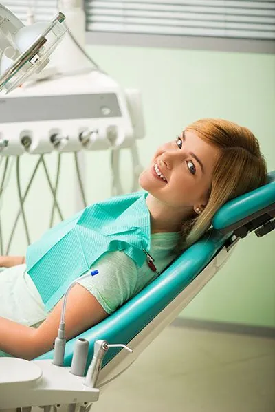 woman smiling during her dental appointment at Gateway Oaks Dental