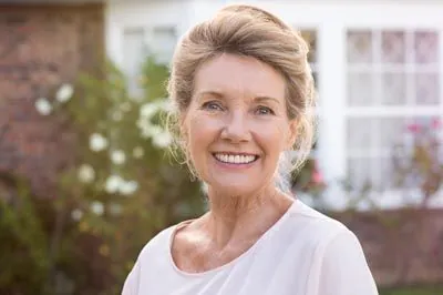 woman loving her restored smile from Gateway Oaks Dental