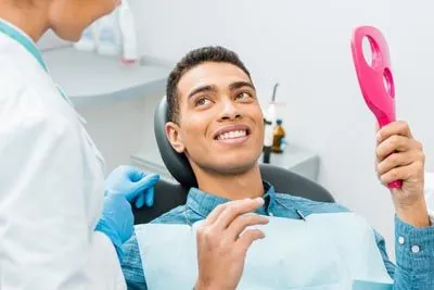 man loving the results of his cosmetic dentistry procedure from Gateway Oaks Dental