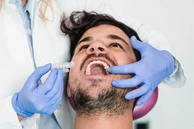 man being fitted for SureSmile clear aligners at Gateway Oaks Dental