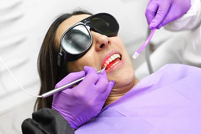 woman getting OraCare Rinse at Gateway Oaks Dental