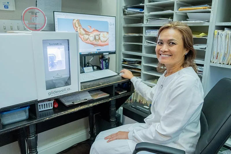 Dr. with dental milling machine in Sacramento, CA