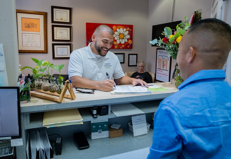 Patient filling out patient forms at front desk
